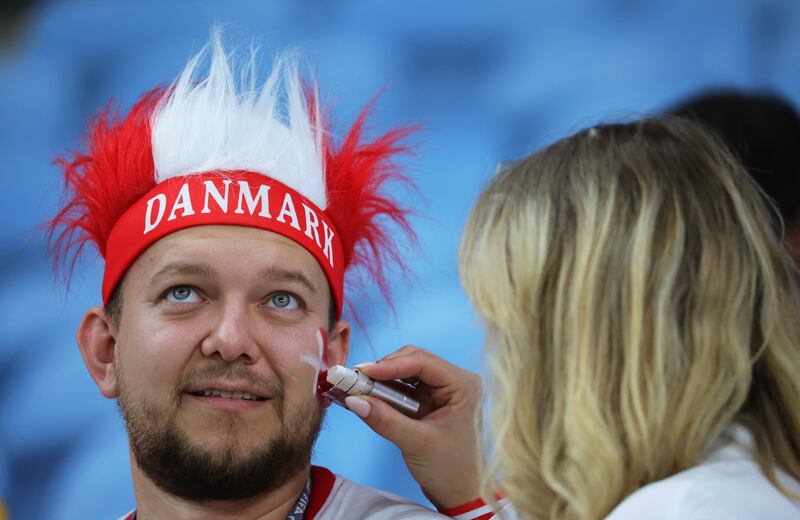 A Denmark fan has his face painted in national colours. EPA