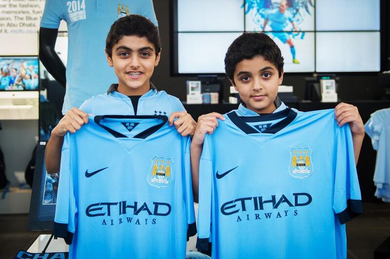 Brothers Mubarak and Majed Al Junaibi with the new Manchester City kit. Courtesy of Jonathan GIbbons / Seven Media