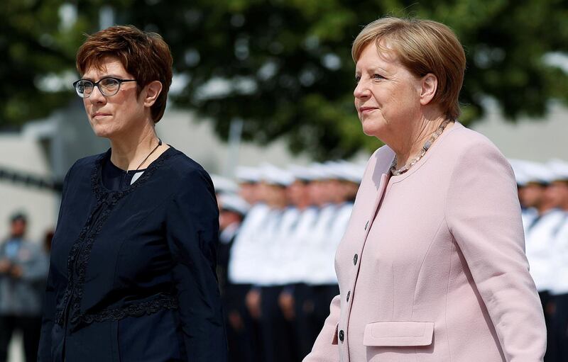 FILE PHOTO: German Defence Minister Annegret Kramp-Karrenbauer and German Chancellor Angela Merkel attend the ceremonial swearing-in of German armed forces Bundeswehr soldiers in Berlin, Germany, July 20, 2019. REUTERS/Fabrizio Bensch/File Photo