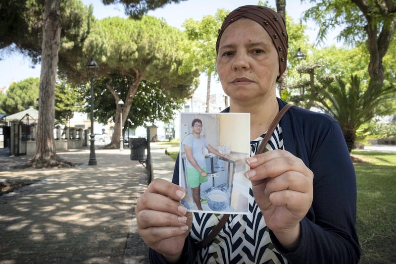 Iliass Tahiri's mother Khadijaholding a photo of her son. Marcos Moreno