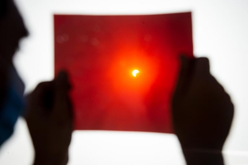 A man uses an X-ray plate to observe an annular partial solar eclipse in Cairo, Egypt. EPA