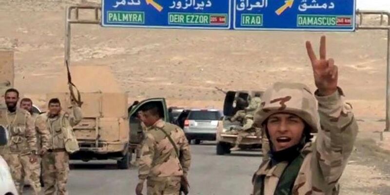 Forces loyal to Syrian president Bashar Al Assad gesture as they advance into the historic city of Palmyra in this picture provided by SANA on March 24, 2016. SANA/Handout via Reuters 