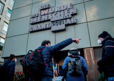 People queue in front of the Frankfurt courthouse where Syrian doctor Alaa Mousa is being tried for crimes agains humanity. AP