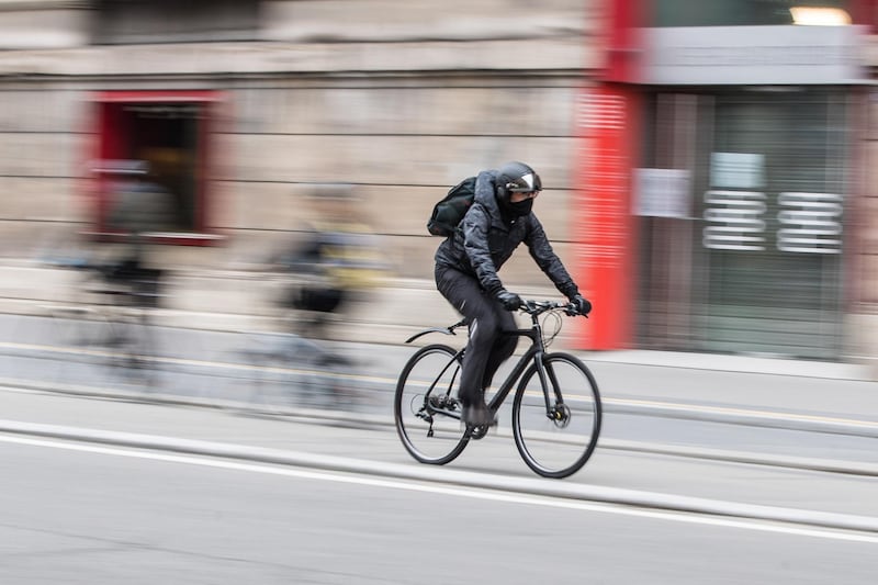 epa08414739 A picture taken in high exposure shows a man with protection mask riding a bike next to The Musee des Arts Decoratifs 'Museum of Decorative Arts' at the Rue de Rivoli street on the first day of the easing of lockdown in Paris, France, 11 May 2020. France begins a gradual easing of lockdow measures and restrictions although the Covid-19 pandemic remains active. In Paris, workers need an attestation from their employer to justify using public transports.  EPA/MOHAMMED BADRA