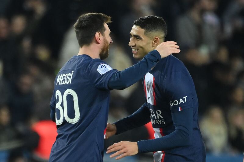 Paris Saint-Germain's Argentine forward Lionel Messi (L) celebrates with Paris Saint-Germain's Moroccan defender Achraf Hakimi after scoring his team's second goal during the French L1 football match between Paris Saint-Germain (PSG) and Toulouse FC at the Parc des Princes stadium in Paris on February 4, 2023.  (Photo by FRANCK FIFE  /  AFP)