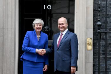 Britain’s Prime Minister Theresa May shakes hands with Iraq’s President Barham Salih in London on Tuesday. Reuters
