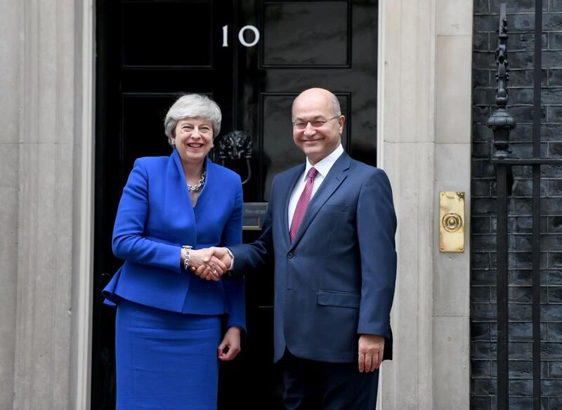 Britain's Prime Minister Theresa May shakes hands with Iraq's President Barham Salih in London, Britain June 25, 2019.  The Presidency of the Republic of Iraq Office /Handout via REUTERS ATTENTION EDITORS - THIS PICTURE WAS PROVIDED BY A THIRD PARTY