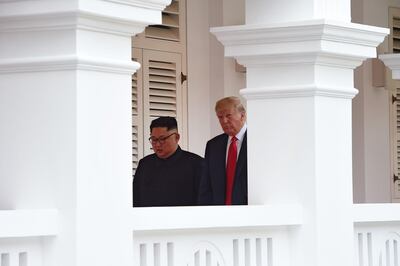 North Korea's leader Kim Jong Un (L) walks out with US President Donald Trump (R) to face the media after taking part in a signing ceremony at the end of their historic US-North Korea summit, at the Capella Hotel on Sentosa island in Singapore on June 12, 2018. Donald Trump and Kim Jong Un became on June 12 the first sitting US and North Korean leaders to meet, shake hands and negotiate to end a decades-old nuclear stand-off. / AFP / POOL / Anthony WALLACE
