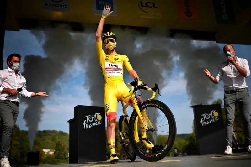 Slovenian rider Tadej Pogacar of the UAE Team Emirates, bearer of the Yellow T-shirt waves from the podium before the start of the 21st and last stage of the Tour de France 2020 cycling race over 122km from Mantes-La-Jolie to Paris, France.  EPA