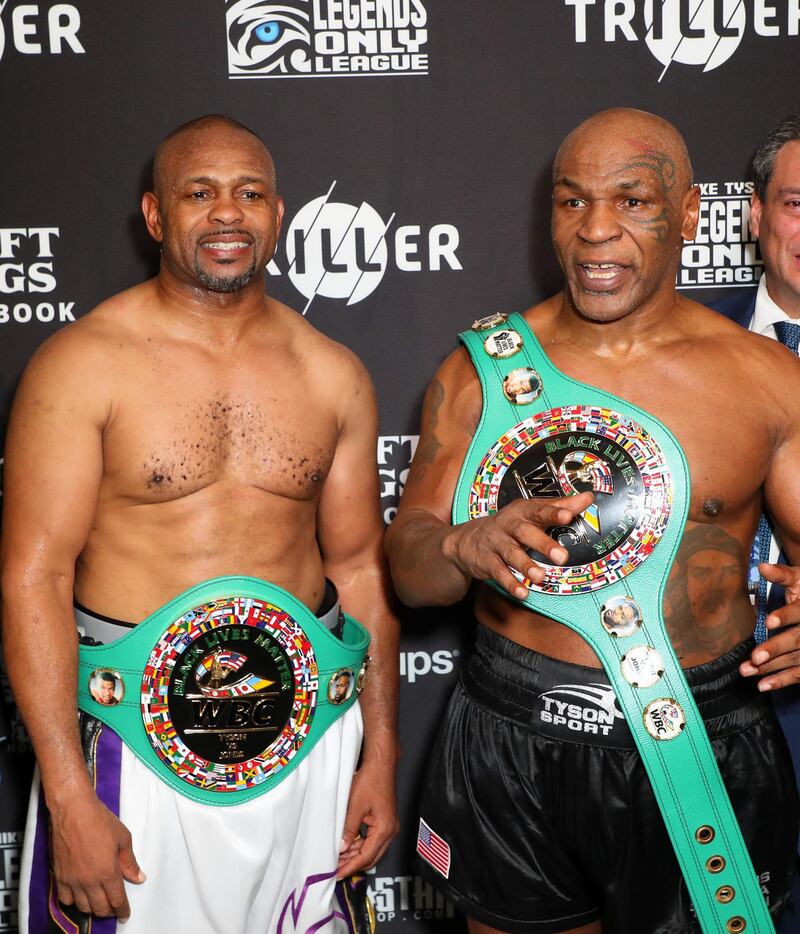Mike Tyson and Roy Jones, Jr. pose with their belts after a split draw. Reuters