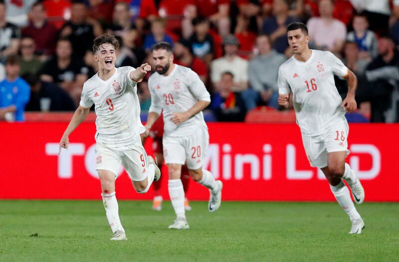 Gavi celebrates scoring Spain's first goal with Rodri and Dani Carvajal. Reuters