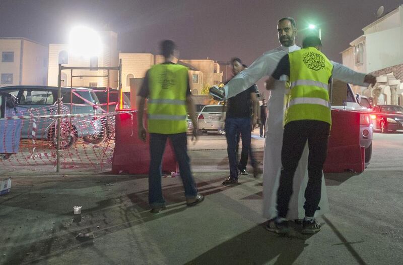 Shiite worshipers are frisked by members of security as they make their way to a hussainiya – a Shiite hall used for commemorations – in the Saudi Arabian town of Qatif, on October 16, 2015. Hussein Radwan/AFP Photo

