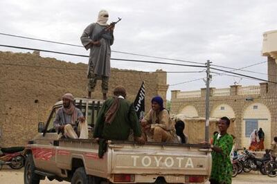 Fighters with the Al Qaeda-linked group Ansar Dine stand guard in Timbuktu. AP 