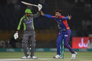 Karachi Kings's Mohammad Amir (R) makes an appeal for caught behind the wickets against Lahore Qalandars's captain Sohail Akhtar during the T20 cricket match between Lahore Qalandars and Karachi Kings at the National Cricket Stadium in Karachi March 12, 2020. / AFP / Asif HASSAN