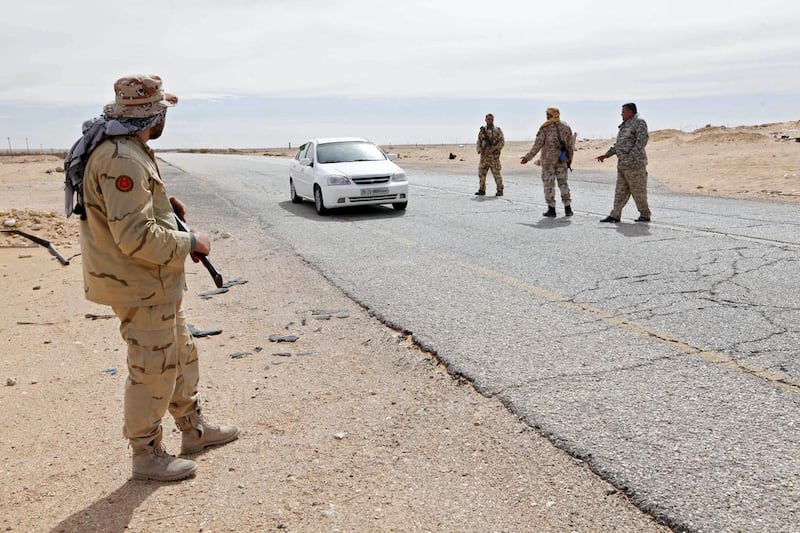 Libyan soldiers manning a military outpost, stop a car at a checkpoint in Wadi Bey, west of the city of Sirte, which is held by Islamic State militants. Ismail Zitouny / Reuters