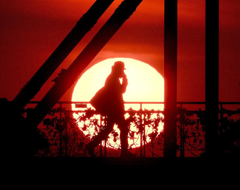 The sun rises behind the 'Eiserne Steg' pedestrian bridge in Frankfurt, Germany. AP Photo