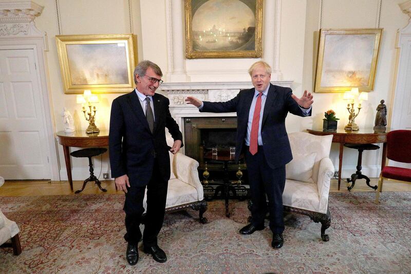 Britain's Prime Minister Boris Johnson (R) interacts with European Parliament president David Sassoli prior to a private meeting at 10 Downing Street for a meeting in London on October 8, 2019.  Brexit talks between Britain and the European Union appeared to be on the verge of collapse on Tuesday, with Brussels accusing London of intransigence and threatening the bloc's future. / AFP / Aaron Chown
