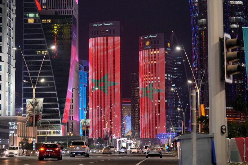 The Moroccan flag is projected on tower blocks in the city center of Doha, Qatar, after Morocco beat Spain. AP Photo