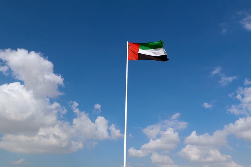 Dubai, United Arab Emirates - December 08, 2020: Weather. Strong winds blow the UAE flag up at Al Qudra cycle track. Tuesday, December 8th, 2020 in Dubai. Chris Whiteoak / The National