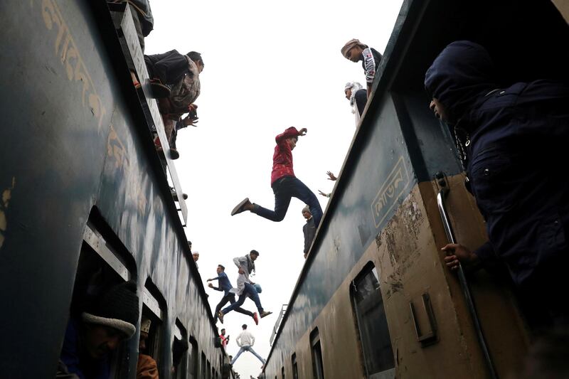 People jump between trains in Tongi, Bangladesh, to attend at the final prayer of Bishwa Ijtema, which is considered the world's second-largest Muslim gathering after Hajj.  Reuters