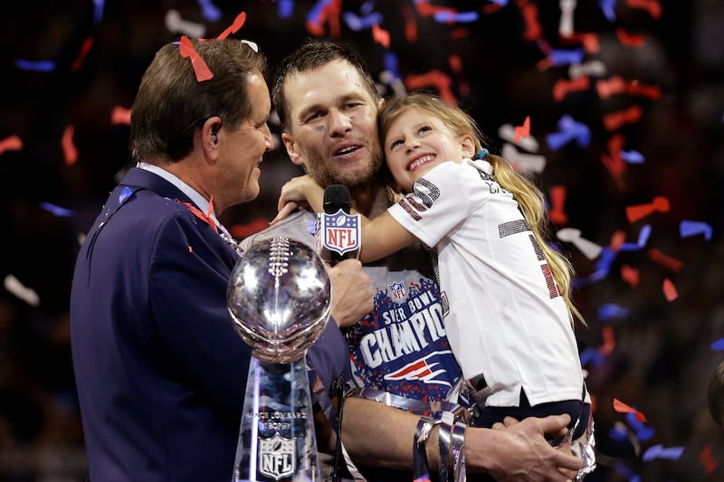 Patriots' Tom Brady holds his daughter, Vivian, after the  Super Bowl victory against the Los Angeles Rams in 2019, in Atlanta. The Patriots won 13-3. AP