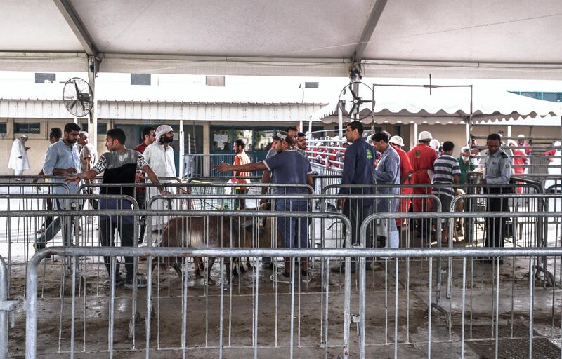 Abu Dhabi, U.A.E., August 22 , 2018.  Livestock shoppers for the second day of Eid Al Adha at the Abu Dhabi Livestock Market and the Abu Dhabi Public Slaughter House (Abu Dhabi Municipality) at the  Mina area.-- Delivery area.  This is where the livestock market worker gives the livestock to the slaughter house worker and gives instructions for the desired cut of the customer.
Victor Besa/The National
Section:  NA
For:  stand alone and stock images