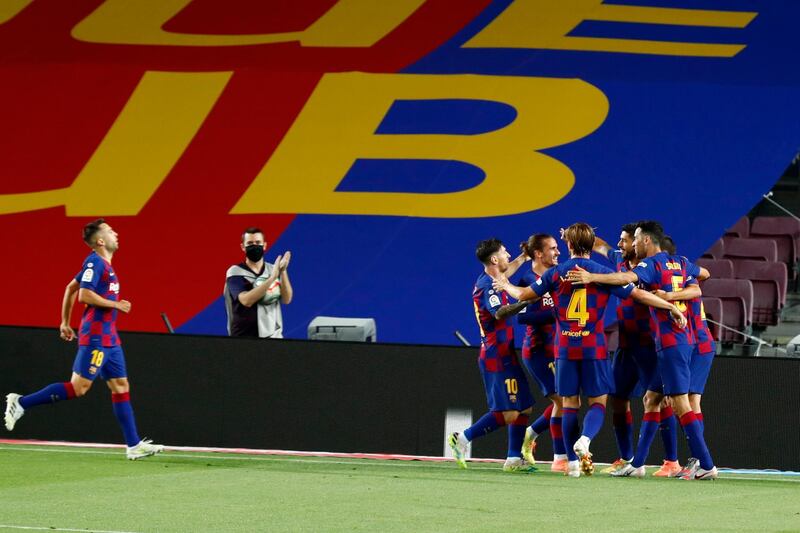 Luis Suarez celebrates with teammates after scoring the opening goal for Barcelona against Espanyol. AP Photo
