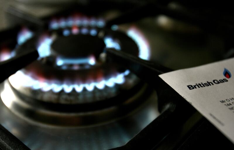 A lit gas hob sits next to a bill from British Gas, which announced it will exit gas supply agreements with its Russian counterparts. PA