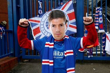 A Rangers fan wears a Steven Gerrard mask outside of the Ibrox Stadium, home of Rangers FC. Picture date: Sunday March 7, 2021. PA Photo. Rangers will be crowned Scottish Premiership champions if Celtic fail to win at Dundee United. See PA story SOCCER Rangers. Photo credit should read: Robert Perry/PA Wire.