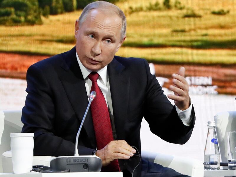 Russian President Vladimir Putin gestures as he speaks during a plenary session at the Eastern Economic Forum in Vladivostok, Russia, Wednesday, Sept. 12, 2018. Putin says Russia has identified the two men that Britain named as suspects in the poisoning of a former Russian spy and that there is "nothing criminal" about them. (AP Photo/Dmitri Lovetsky)