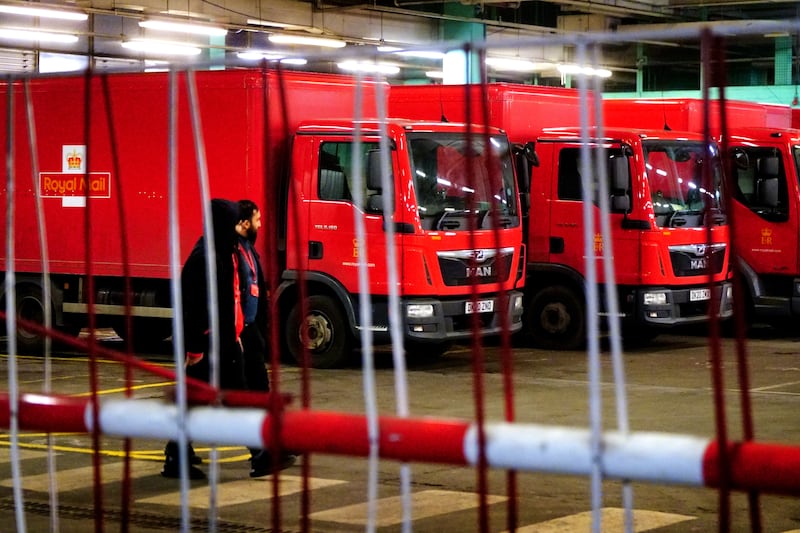 Royal Mail delivery lorries parked idle in the Whitechapel delivery depot. PA