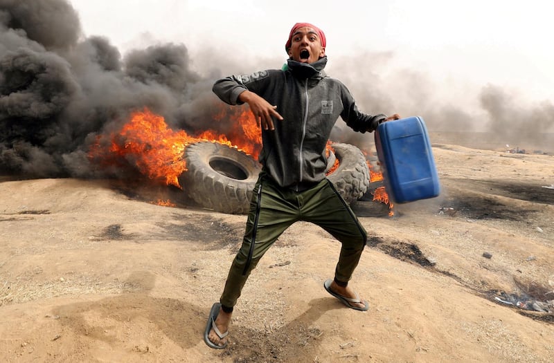FILE PHOTO: A Palestinian demonstrator during clashes with Israeli troops at a protest on the Israel-Gaza border where Palestinians demand the right to return to their homeland, April 20, 2018. REUTERS/Mohammed Salem/File Photo