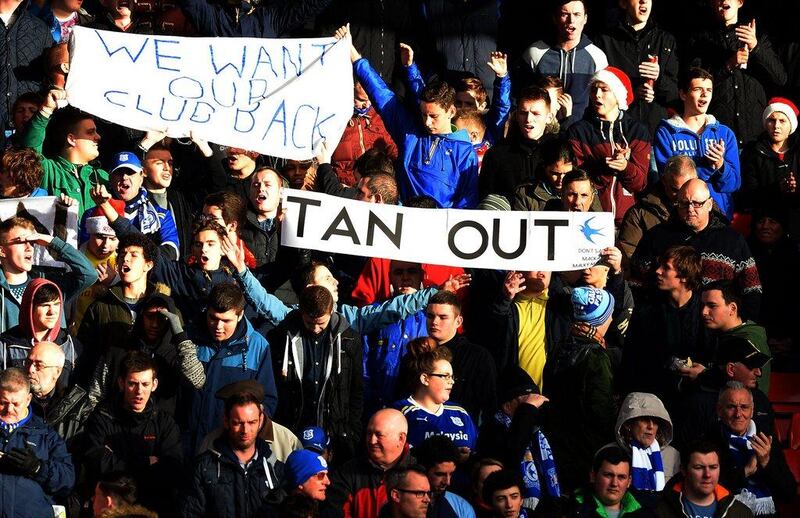 Cardiff's fans express their displeasure with owner Vincent Tan with their signage. Paul Ellis / AFP