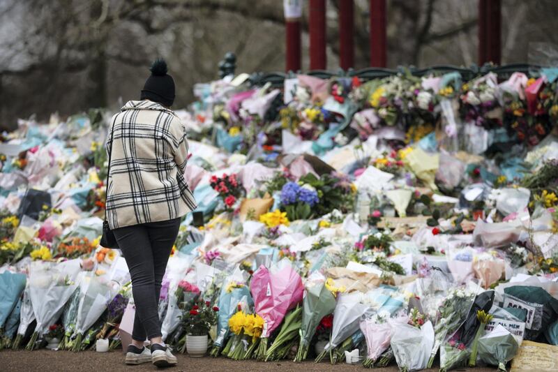 A woman visits a memorial site at the Clapham Common Bandstand, following the kidnap and murder of Sarah Everard, in London, Britain March 16, 2021. REUTERS/Hannah McKay