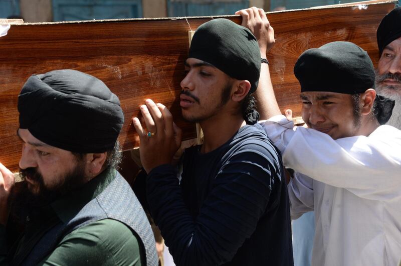 Afghan Sikhs carry the coffin of one of the 19 victims of a suicide attack in Jalalabad on July 2, 2018, a day after the attack. Grief mixed with anger among Afghanistan's minority Sikh and Hindu community on July 2 as they prepared for funerals of loved ones, including an election candidate, killed in a suicide attack.
 / AFP / NOORULLAH SHIRZADA

