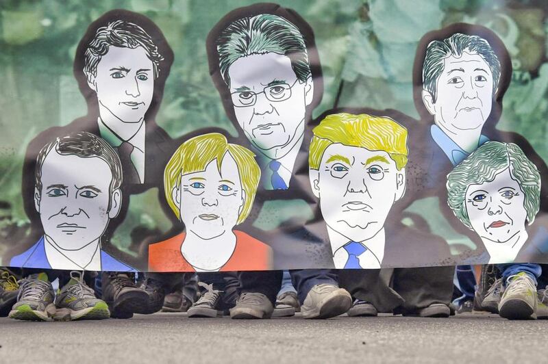 Demonstrators carry a banner with the caricatures of the world leaders, during a ‘No G7’ protest outside the G7 summit in Giardini Naxos, near Taormina, Sicily. Ciro Fusco / EPA