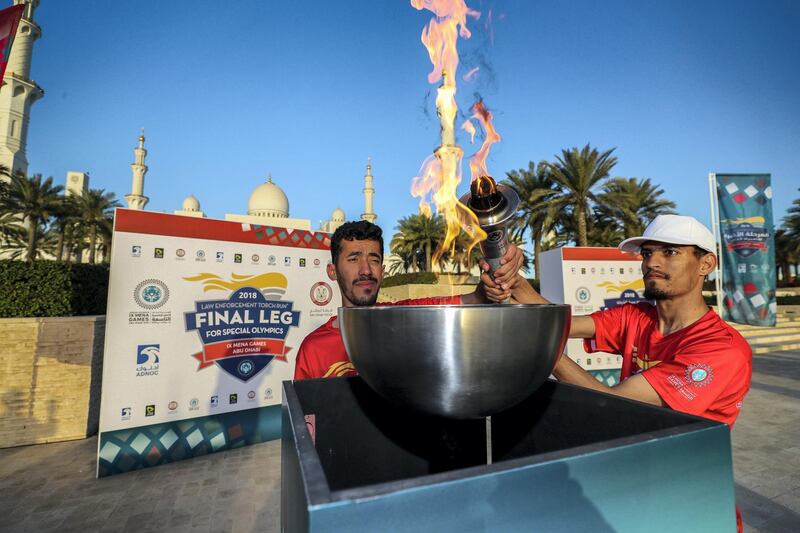 Abu Dhabi, UAE.  March, 14, 2018.  Law Enforcement Torch Run, Final Leg for Special Olympics.  (L) Khalif Al Neimi and Abdullah Shirari light up the earn infront of the Abu Dhabi Grand Mosque.
Victor Besa / The National