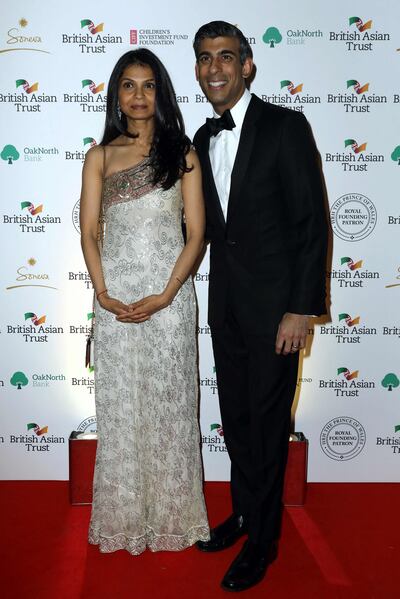 In this photo taken on February 9, 2022, Britain's Chancellor of the Exchequer Rishi Sunak poses with his wife, Akshata Murty, during a reception to celebrate the British Asian Trust at The British Museum in London. AFP