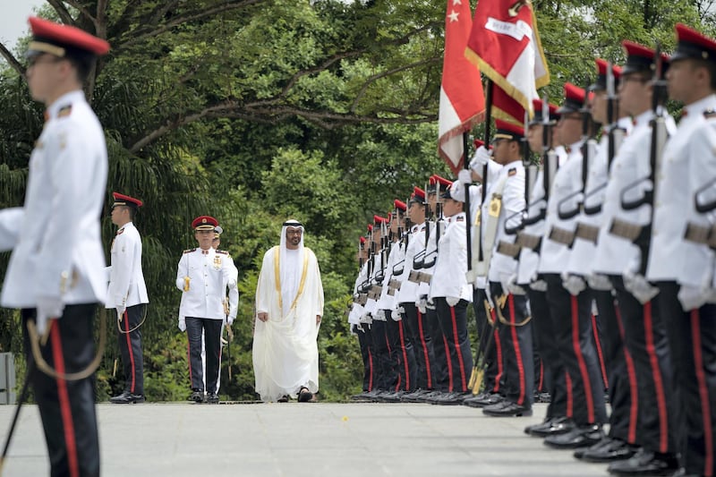 SINGAPORE, SINGAPORE - February 28, 2019: HH Sheikh Mohamed bin Zayed Al Nahyan, Crown Prince of Abu Dhabi and Deputy Supreme Commander of the UAE Armed Forces (C), inspects the honour guard during a reception hosted by HE Halimah Yacob, President of Singapore, (not shown), during a reception at the Istana presidential palace.
( Ryan Carter / Ministry of Presidential Affairs )