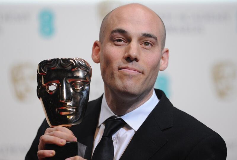 US director Joshua Oppenheimer poses with the award for a documentary for the film “The Act Of Killing.” Carl Court / AFP photo