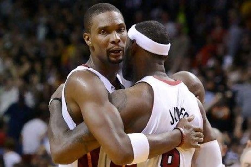 Miami Heat's LeBron James, right, celebrates with Chris Bosh.