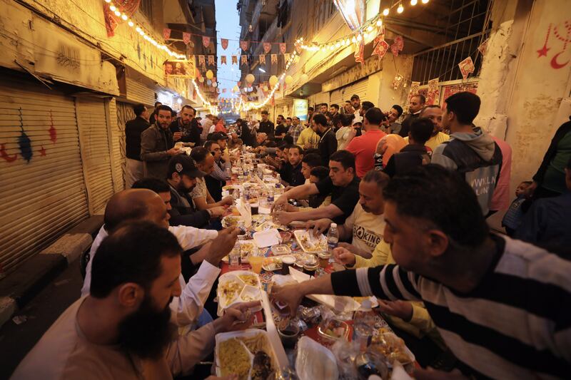 Residents gather in the streets for iftar, in Cairo's Matareya district, during Ramadan last year. EPA