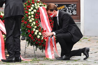 Austrian Chancellor Sebastian Kurz places a candle at a crime scene as he pays his respects to the victims of a shooting in Vienna on November 3, 2020, one day after the shooting at multiple locations across central Vienna. A huge manhunt was under way after gunmen opened fire at multiple locations across central Vienna in the evening of November 2, 2020, killing at least four people in what Austrian Chancellor Sebastian Kurz described as a "repulsive terror attack". / AFP / JOE KLAMAR
