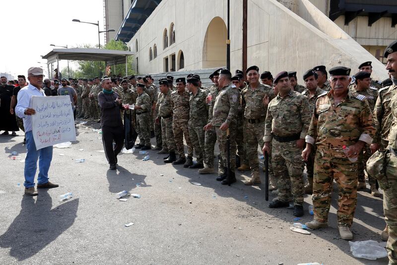 Iraqi policemen during the demonstration.  EPA