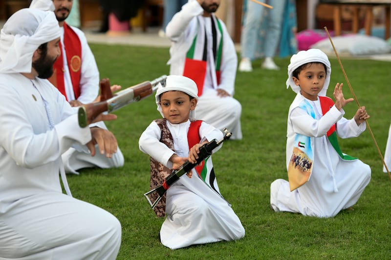 Young boys dance to traditional Emirati music by Al Mazyood band for National Day celebrations, at Mohammed Bin Rashid Library, Dubai. Khushnum Bhandari / The National