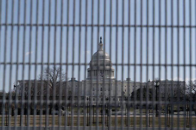 The US Capitol building seen through a mesh security fence. Willy Lowry / The National