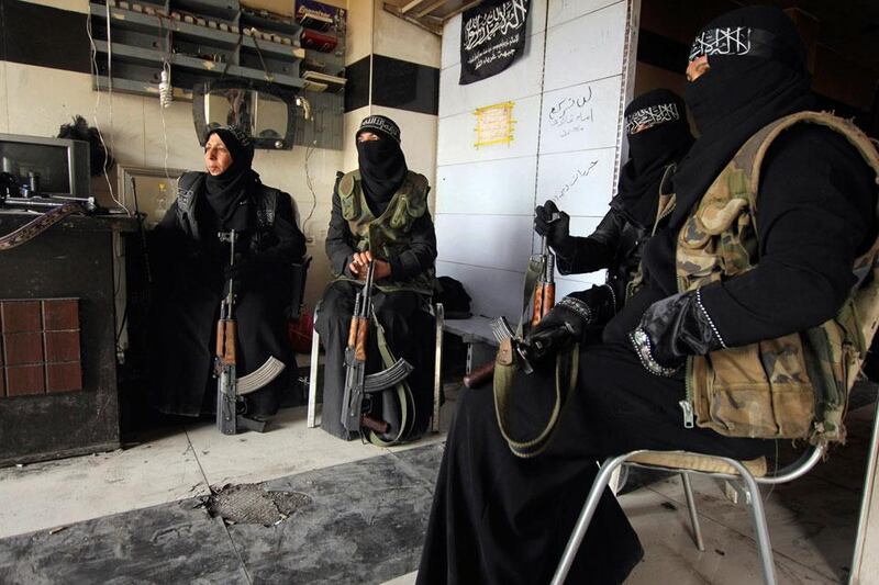 Women at war: female members of the Al Ikhlas (Loyalty) Battalion rest with their weapons in Aleppo, Syria. Giath Taha / Reuters