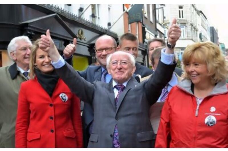 Michael Higgins, centre, campaigning with supporters in Dublin's Henry Street earlier this month.