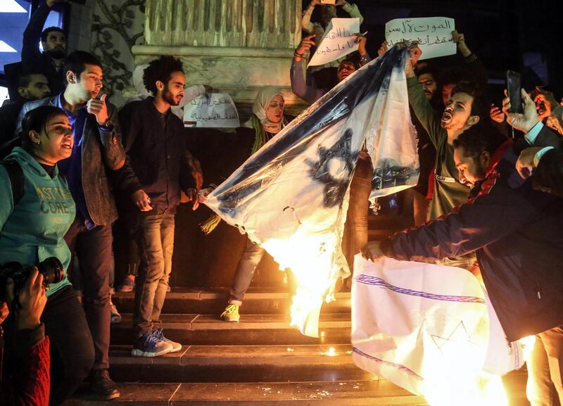 Protesters shouts slogans against US President Donald J Trump and burn Israeli  flag during a protest against the Israel in Cairo, Egypt. Mohamed Elraai/ EPA