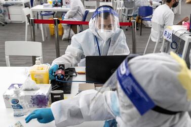 ABU DHABI, UNITED ARAB EMIRATES. 05 AUGUST 2020. The DPI Screening facility along the border between Dubai and Abu Dhabi which screens travellers for the COVID-19 virus using a blood sample and laser technology. It is a quick blood test and results are out in a matter of minutes. Mohamed Khalid has a test conducted by the trained medical staff. (Photo: Antonie Robertson/The National) Journalist: Nick Webster. Section: National.